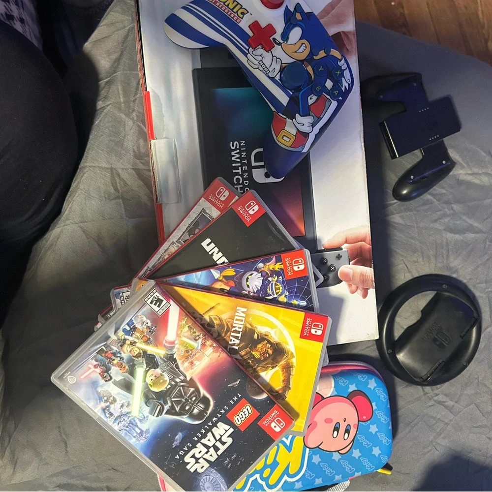 Nintendo Switch with gray Dock, Blue Kirby Case and Sonic Controller Accents,